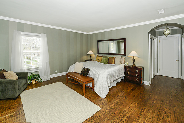 227 Raleigh Road Kenilworth, IL 60043 - Photo 26 of 40 a bedroom with a bed and wooden floor
