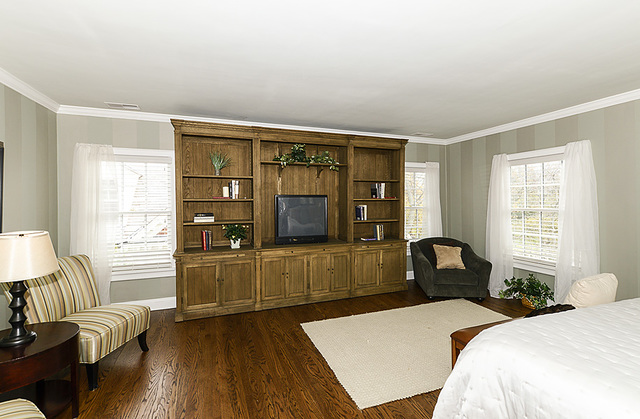 227 Raleigh Road Kenilworth, IL 60043 - Photo 27 of 40 a bedroom with a bed and wooden floor