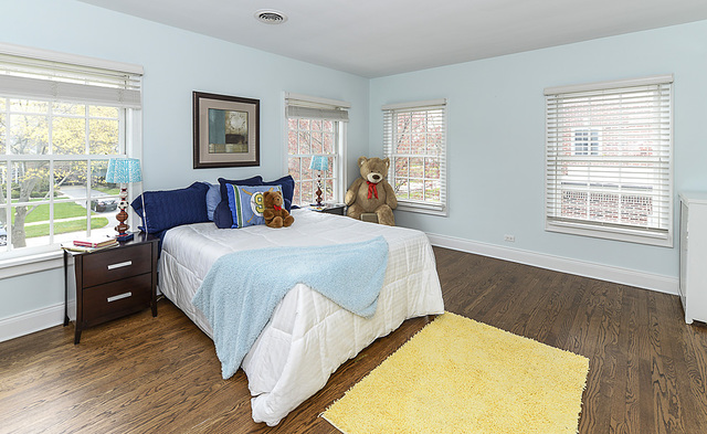 227 Raleigh Road Kenilworth, IL 60043 - Photo 28 of 40 a bedroom with a bed and wooden floor
