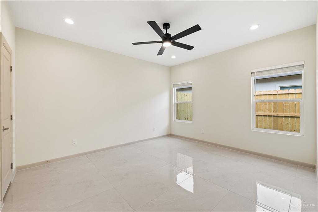1804 West Violet Drive, Unit 1 Pharr, TX 78577 - Photo 11 of 15 an empty room with a window and a ceiling fan