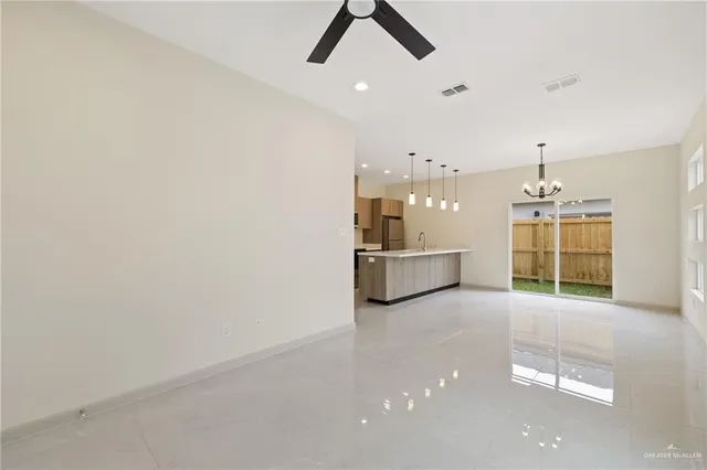 a view of a kitchen with wooden floor and a sink