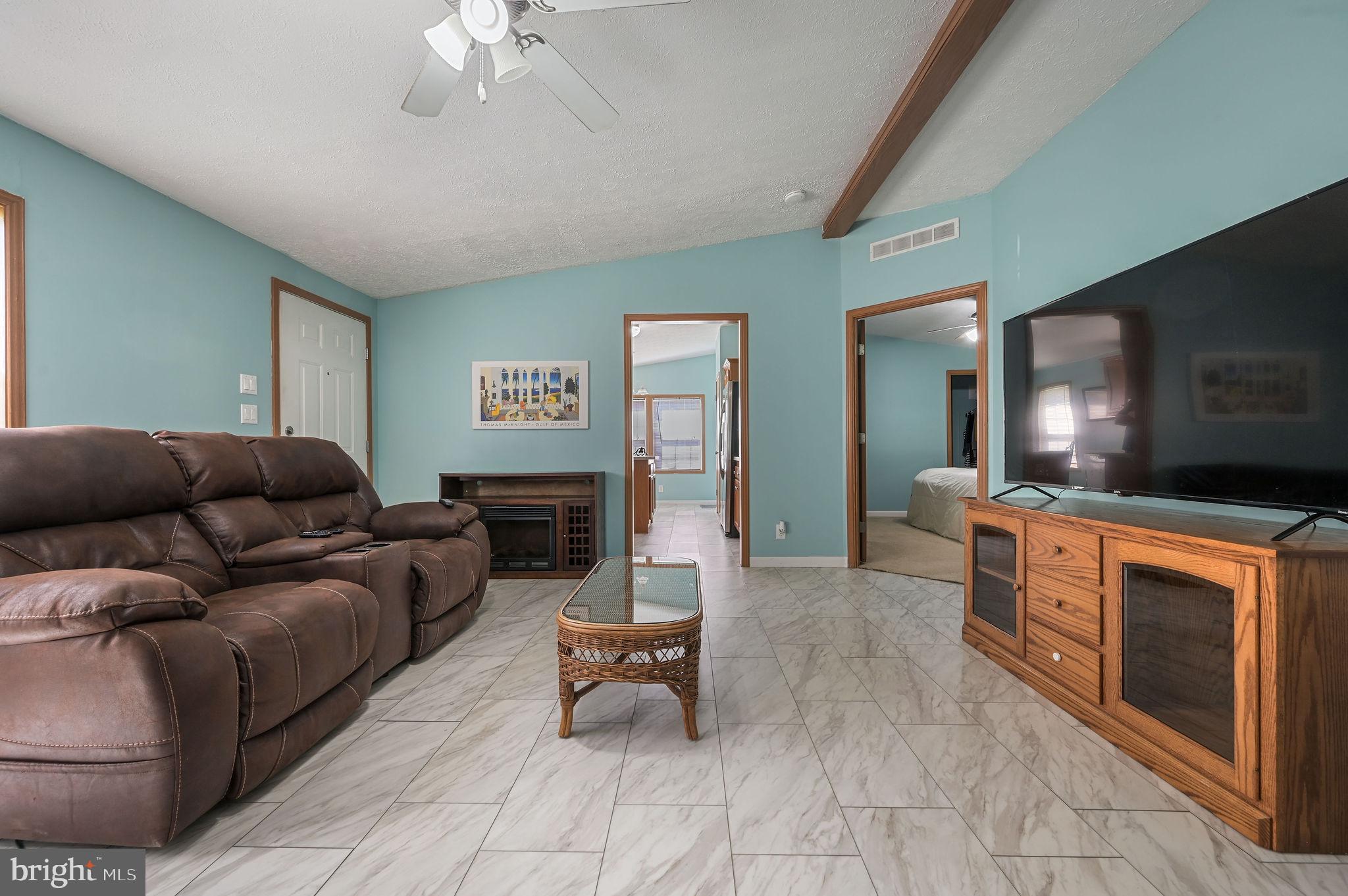 3992 Midstate Road Felton, DE 19943 - Photo 13 of 21 a living room with furniture and a flat screen tv
