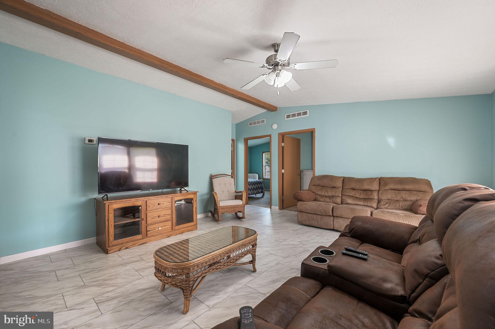 3992 Midstate Road Felton, DE 19943 - Photo 14 of 21 a living room with furniture and a flat screen tv