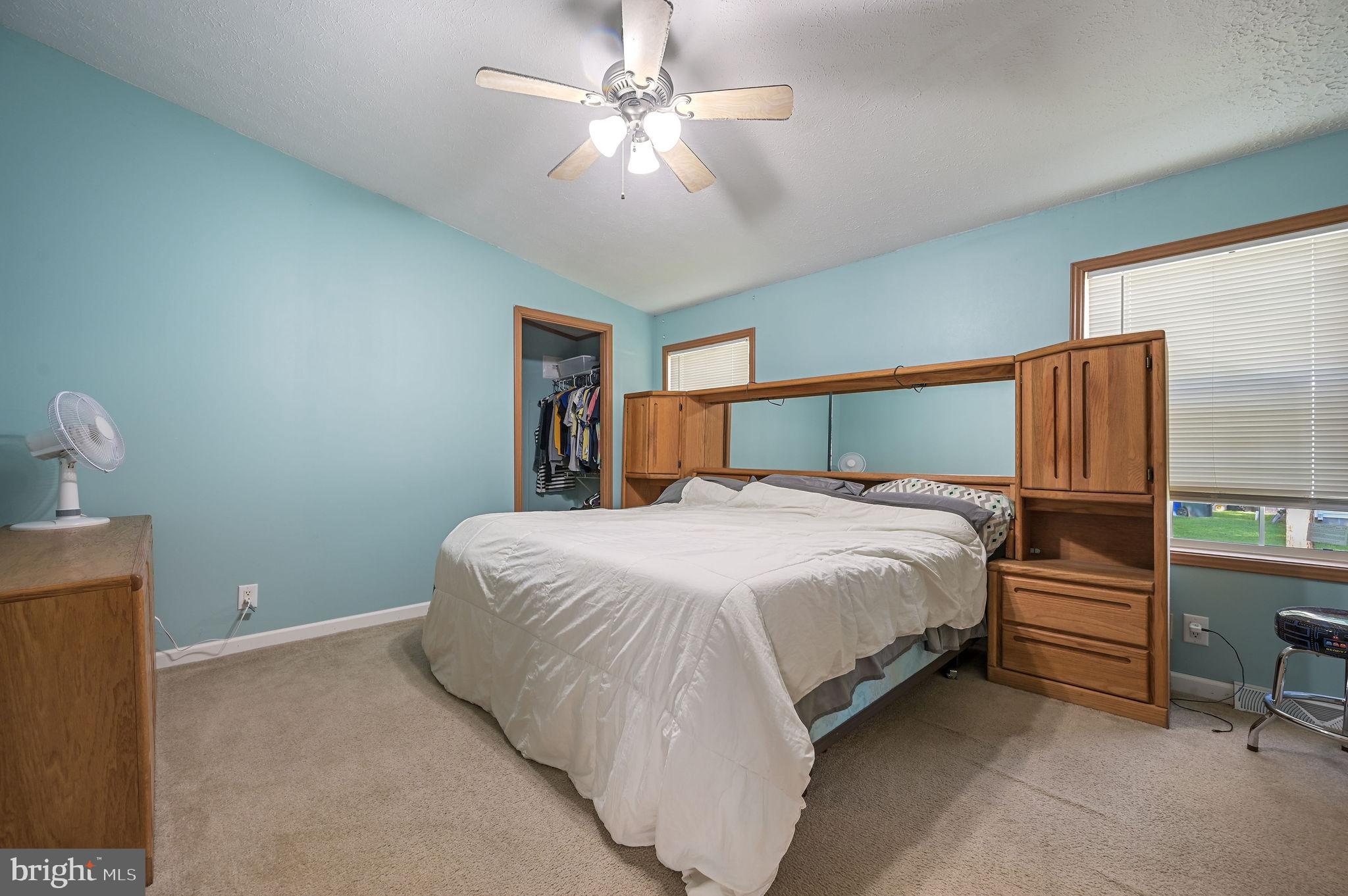 3992 Midstate Road Felton, DE 19943 - Photo 15 of 21 a bedroom with a large bed and a chandelier