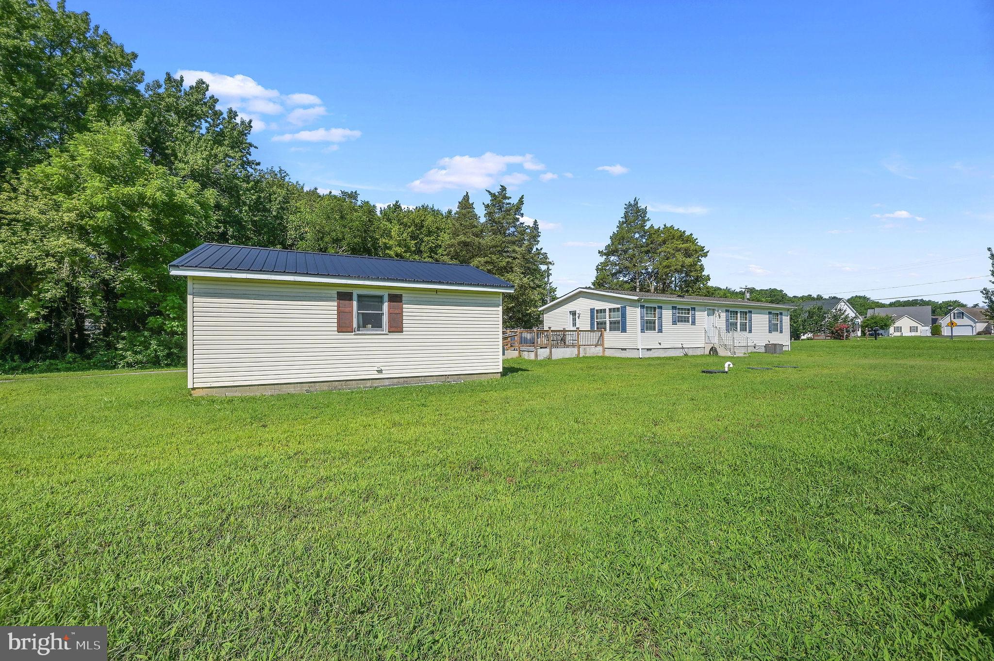 3992 Midstate Road Felton, DE 19943 - Photo 2 of 21 a backyard of a house with lots of green space and garden