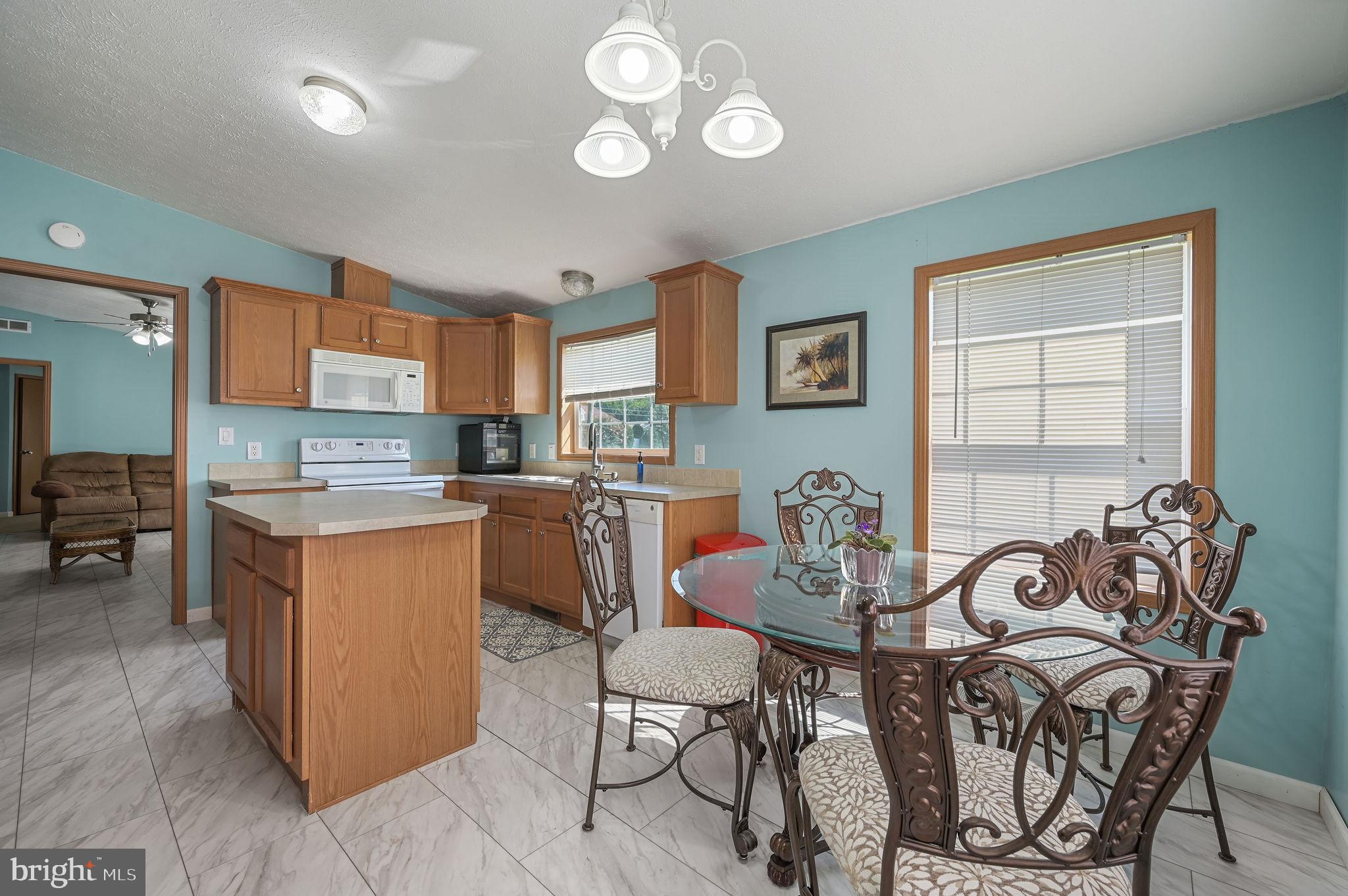 3992 Midstate Road Felton, DE 19943 - Photo 6 of 21 a living room with furniture a dining table and chairs