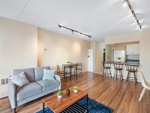 a living room with furniture a dining table with wooden floor