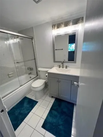 a bathroom with a double vanity sink mirror and toilet