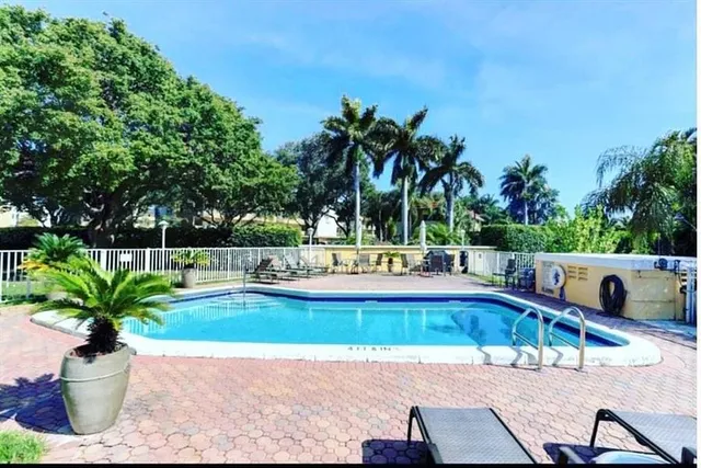 a view of a swimming pool with a lounge chair