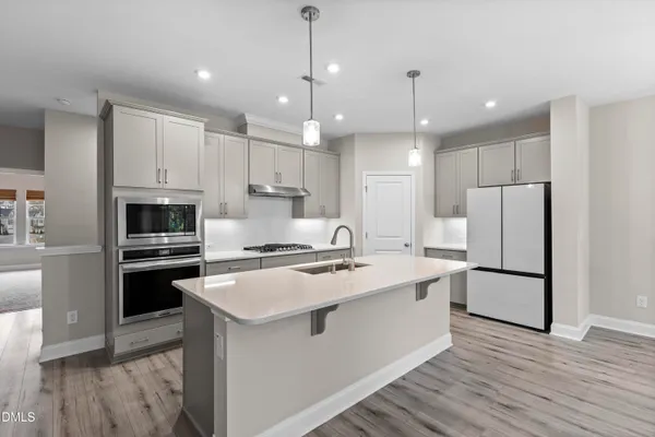 a kitchen with stainless steel appliances a sink stove and cabinets