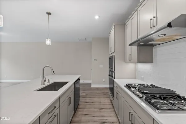 a kitchen with a refrigerator a sink and cabinets