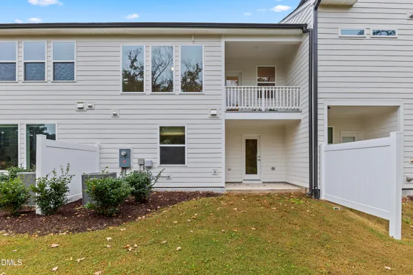 a view of a house with many windows and plants
