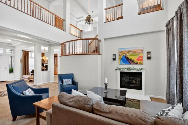 a living room with furniture a fireplace and a window