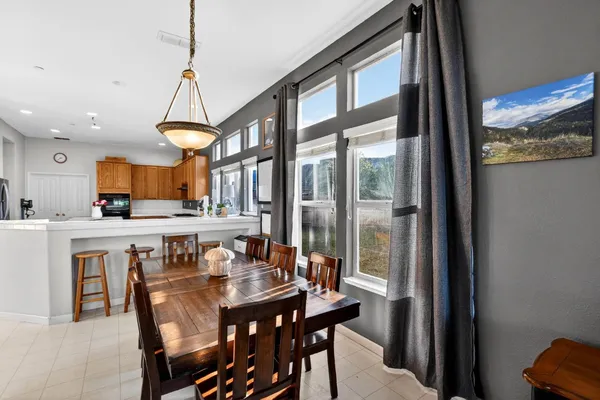 a kitchen with stainless steel appliances granite countertop a sink and a refrigerator