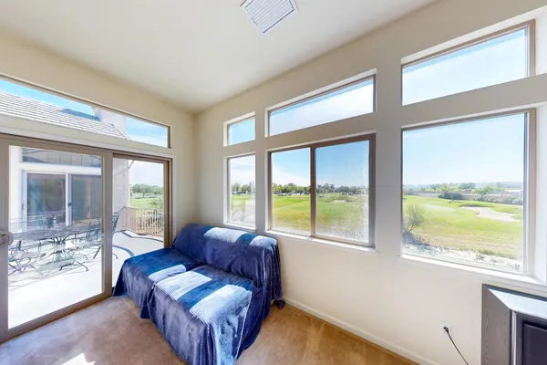 a view of a two chairs and table in the balcony