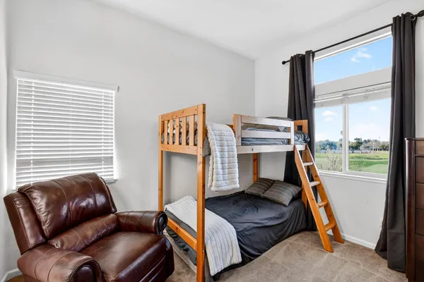 a front view of house with a garden and patio
