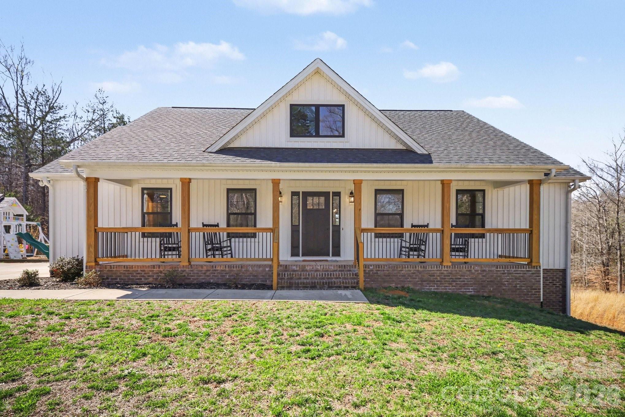 310 Old Hardin Road Dallas, NC 28034 - Photo 1 of 37 a front view of a house with a yard