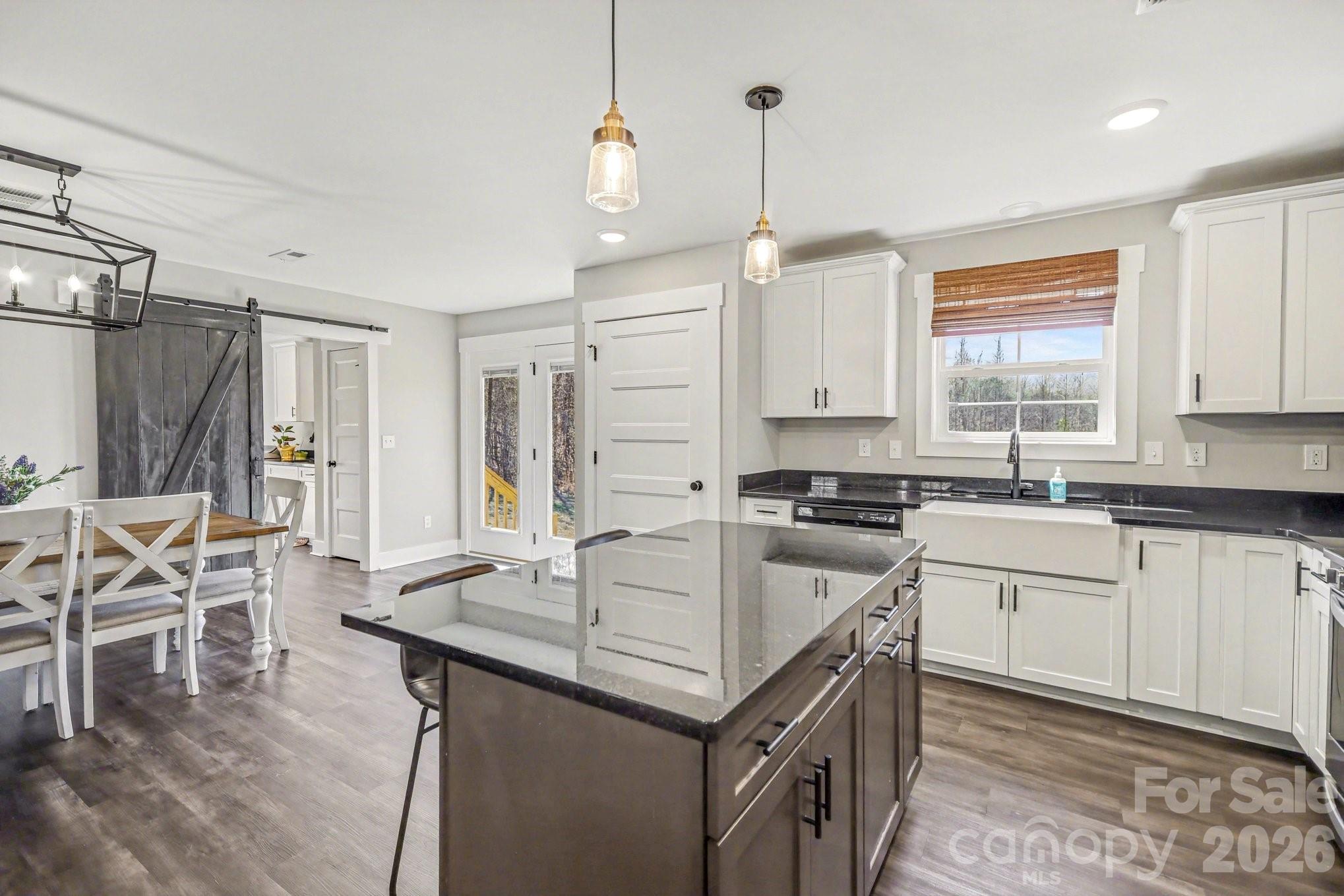 310 Old Hardin Road Dallas, NC 28034 - Photo 13 of 37 a kitchen with granite countertop a sink a counter space appliances and cabinets
