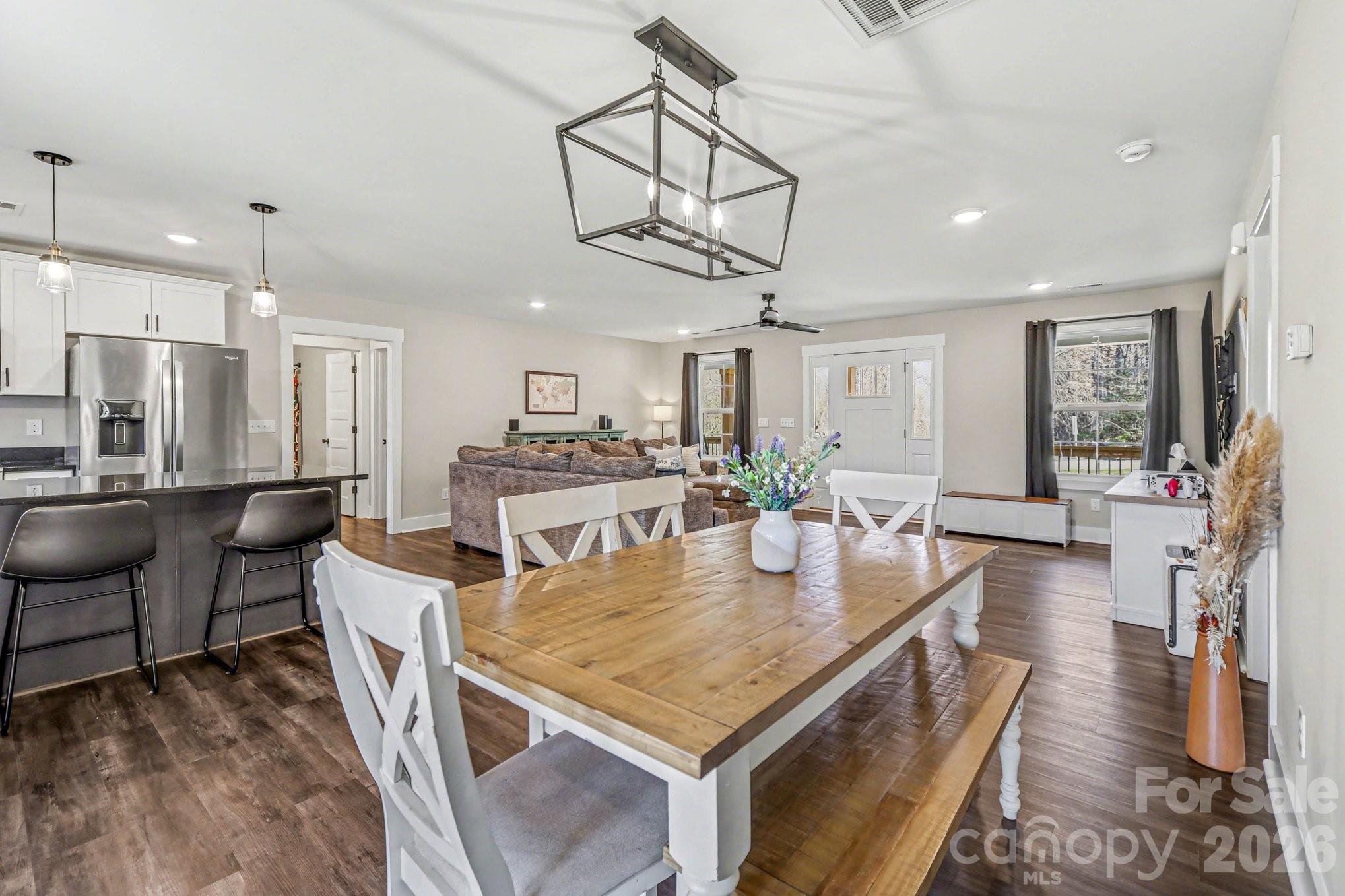 310 Old Hardin Road Dallas, NC 28034 - Photo 19 of 37 a view of a dining room and livingroom with furniture wooden floor a chandelier
