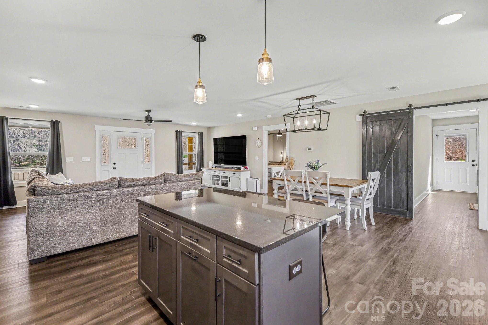 310 Old Hardin Road Dallas, NC 28034 - Photo 10 of 37 a large kitchen with a counter space a sink appliances and living room view