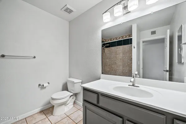 a view of a big room with wooden floor and windows