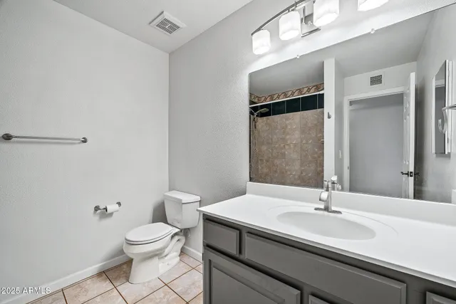 a view of a big room with wooden floor and windows
