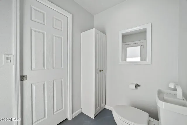 a white toilet sitting next to a bathroom sink