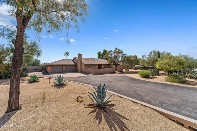 a view of a house with a yard and sitting area