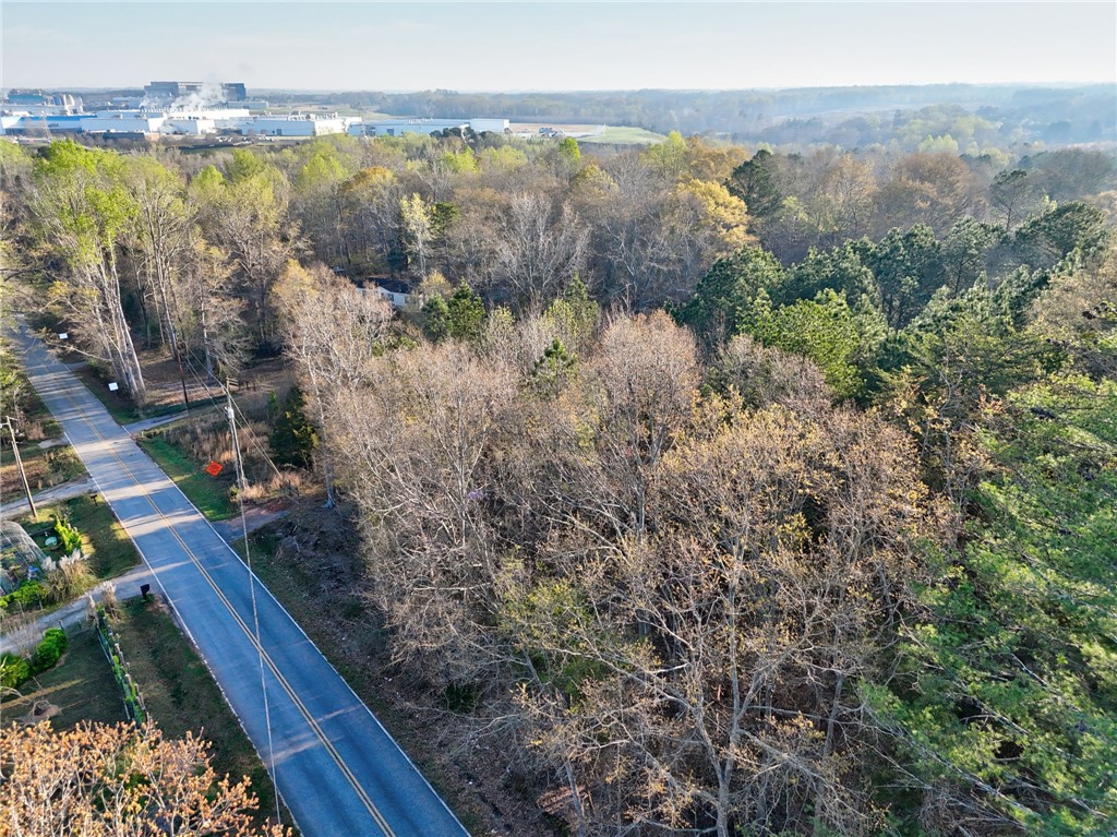 426 Cleveland Road Anderson, SC 29626 - Photo 3 of 10 Vast, undeveloped land with a winding road, surrounded by natural beauty and distant structures.
