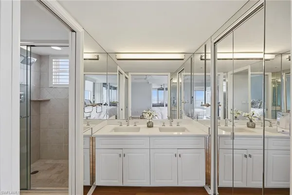 a bathroom with a shower sink and mirror