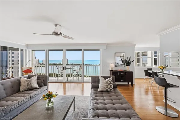 a living room with furniture large window and a table