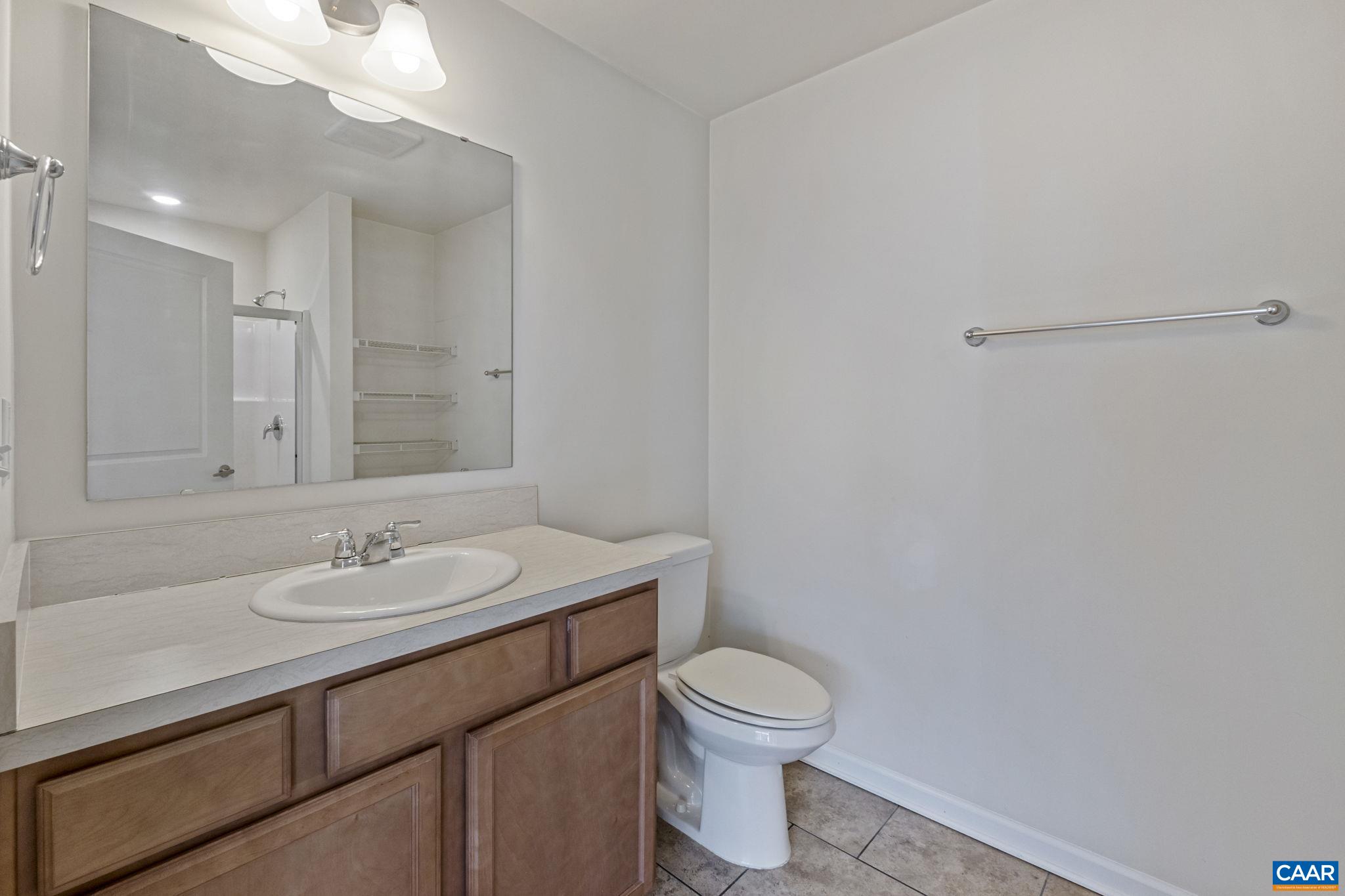 133 Red Hill Road Orange, VA 22960 - Photo 30 of 38 a bathroom with a granite countertop sink a toilet and a mirror