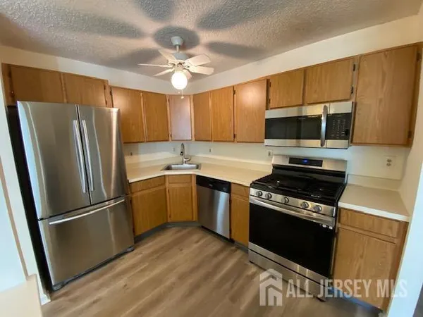 a kitchen with a refrigerator stove and microwave