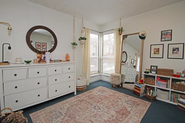 a bedroom with bed and a window