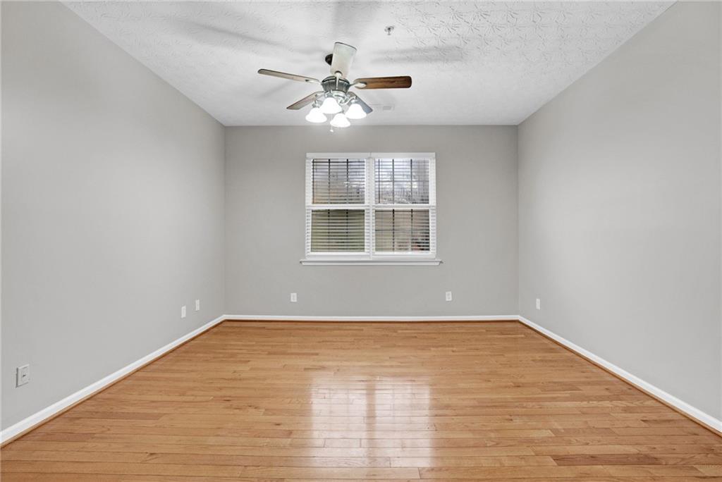 241 Village Square Drive Woodstock, GA 30188 - Photo 13 of 40 a view of an empty room with wooden floor and a window