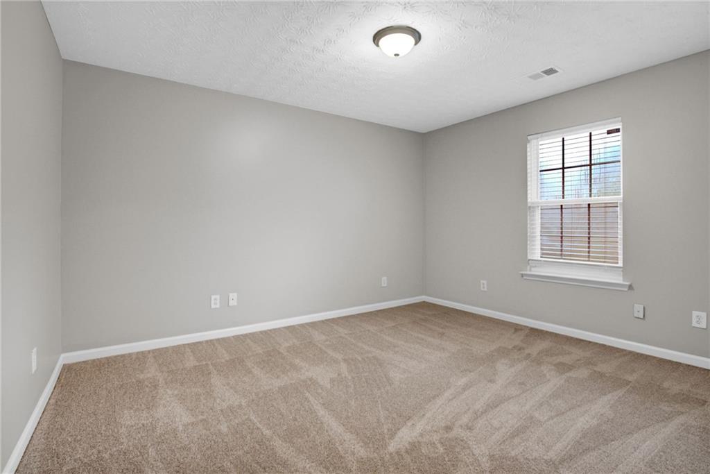 241 Village Square Drive Woodstock, GA 30188 - Photo 14 of 40 an empty room with windows