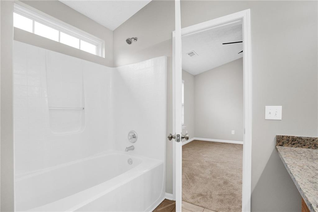 241 Village Square Drive Woodstock, GA 30188 - Photo 27 of 40 a bathroom with a bathtub and shower