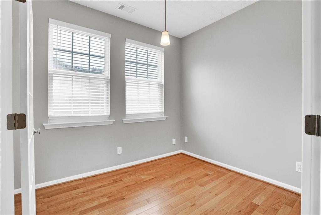 241 Village Square Drive Woodstock, GA 30188 - Photo 3 of 40 a view of a room with wooden floor and windows