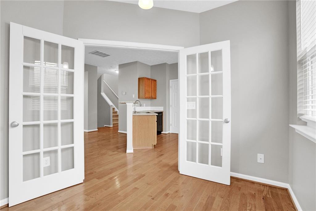 241 Village Square Drive Woodstock, GA 30188 - Photo 5 of 40 a view of an empty room with a window and wooden floor