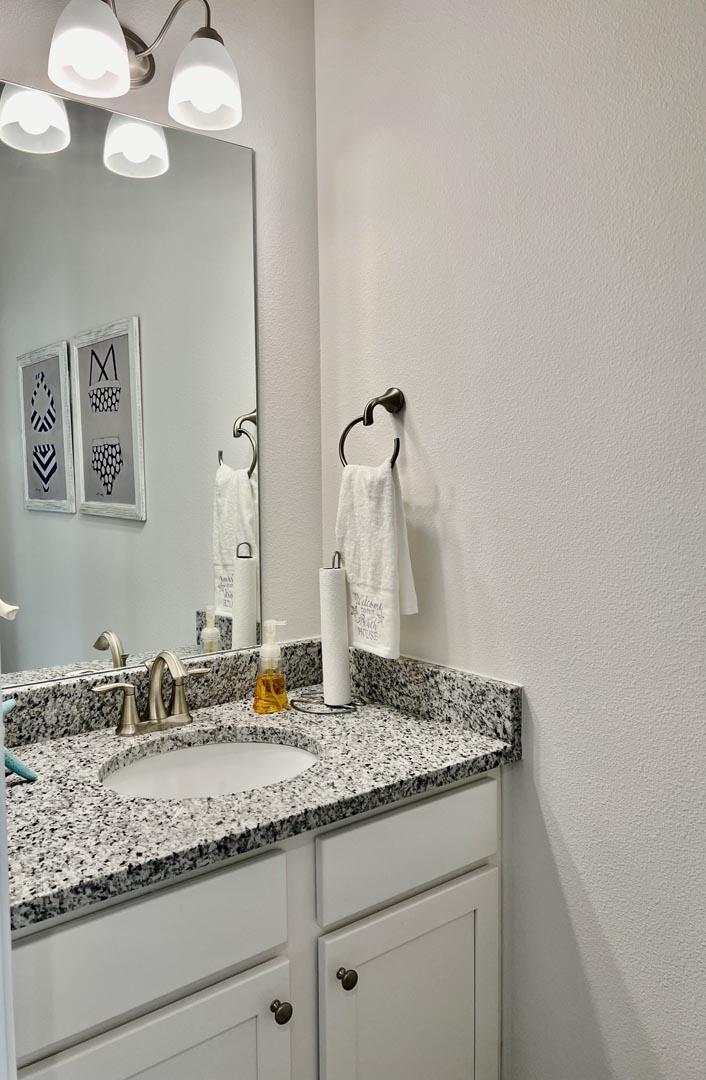 111 Phoenix Street Santa Rosa Beach, FL 32459 - Photo 12 of 13 a bathroom with a granite countertop sink and a mirror