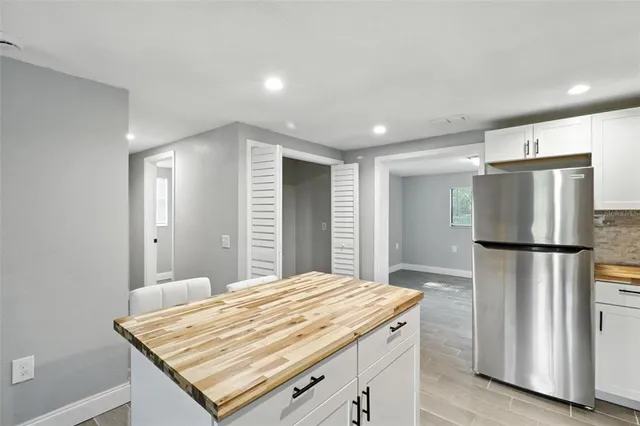 a kitchen with refrigerator and window