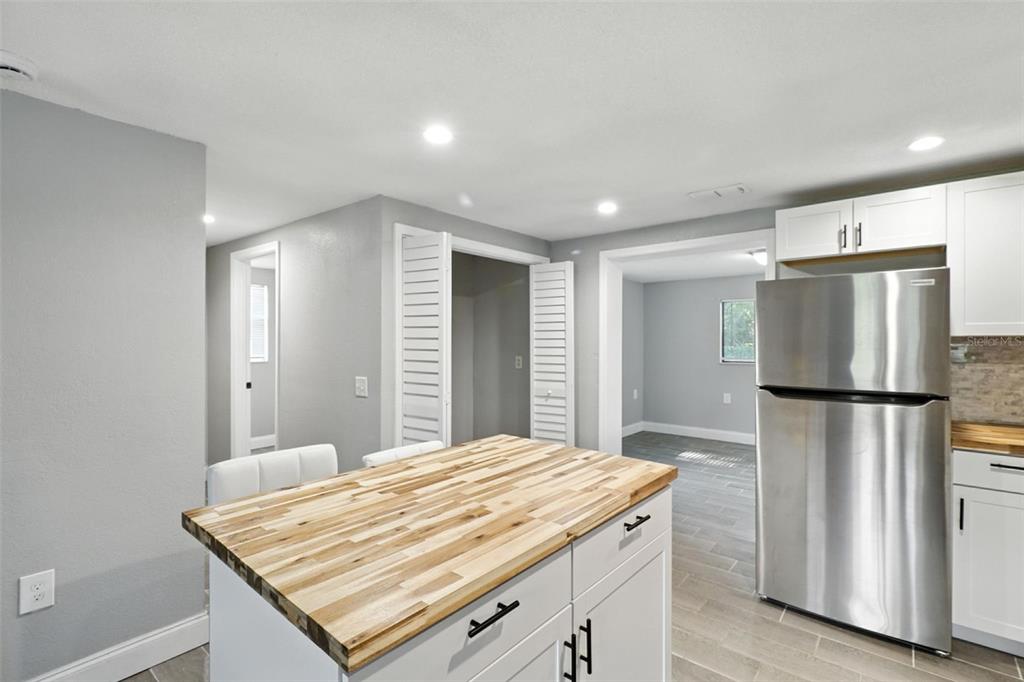 8035 Gulf Way Hudson, FL 34667 - Photo 12 of 26 a kitchen with refrigerator and window