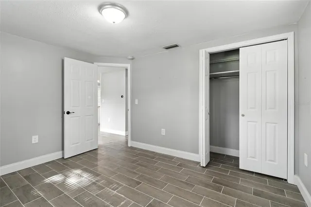an empty room with closet area