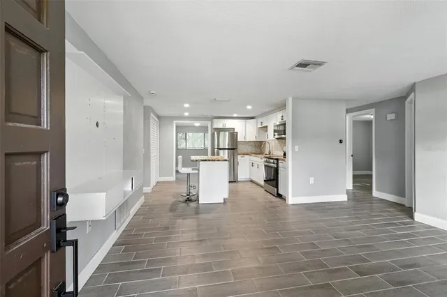 a view of kitchen with furniture and wooden floor