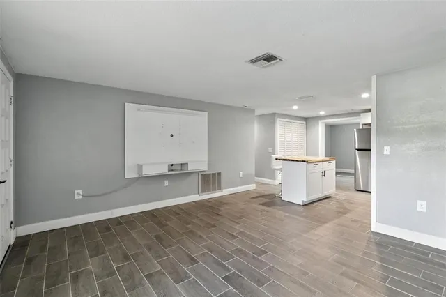a view of a kitchen with a sink and a refrigerator