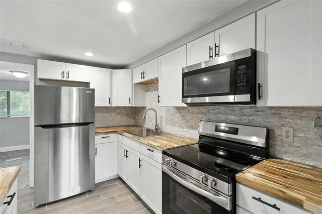 a kitchen with a refrigerator stove and microwave