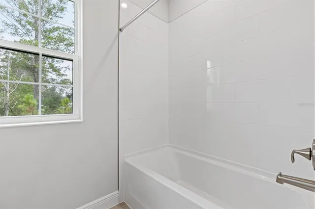 a white bath tub sitting next to a window