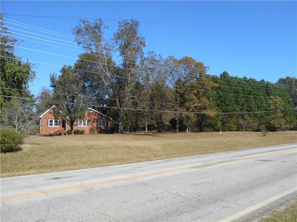 1230 Good Hope Road Monroe, GA 30655 - Photo 17 of 76 an aerial view of a house with a yard and palm trees