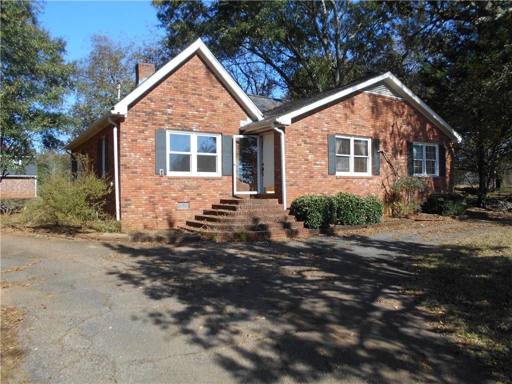1230 Good Hope Road Monroe, GA 30655 - Photo 36 of 76 a front view of a house with a yard and garage