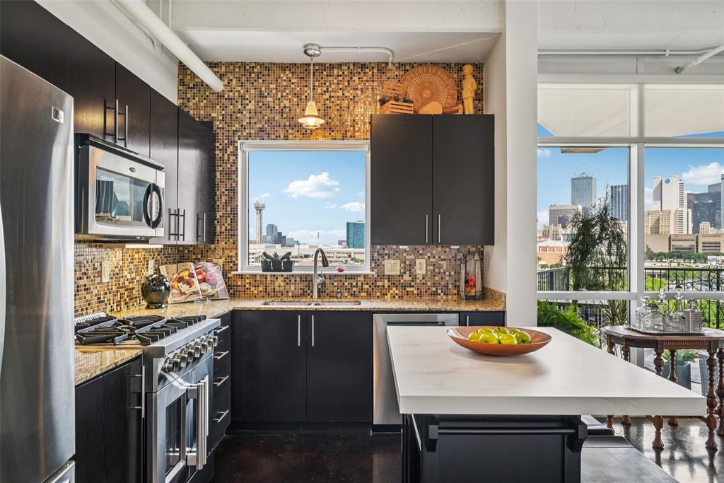 1001 Belleview Street, Unit 708 Dallas, TX 75215 - Photo 14 of 40 a kitchen with a sink a stove and chairs